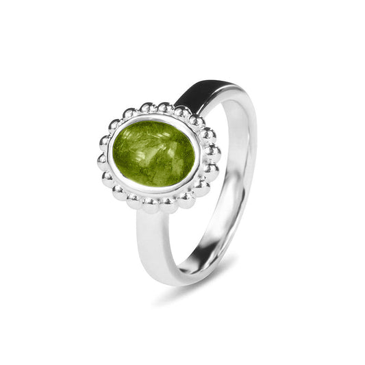 Gedenksieraad, asring 4 mm waar aan de bovenzijde in druppelvorm met parelrand zichtbaar as of haar (of eventueel melktandjes of moedermelk) verwerkt wordt. Green