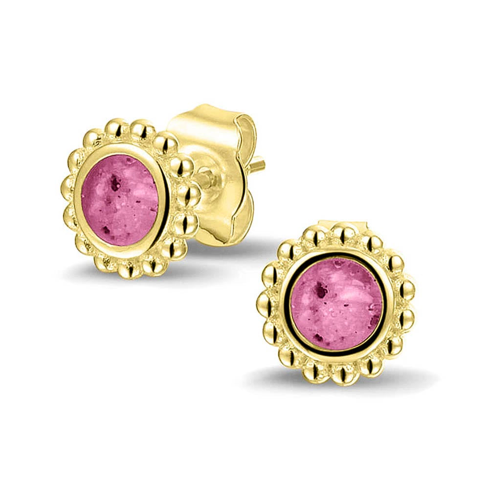 Twee stuks ronde oorstekers 8 mm zichtbaar gevuld met as of haar. Fluo
