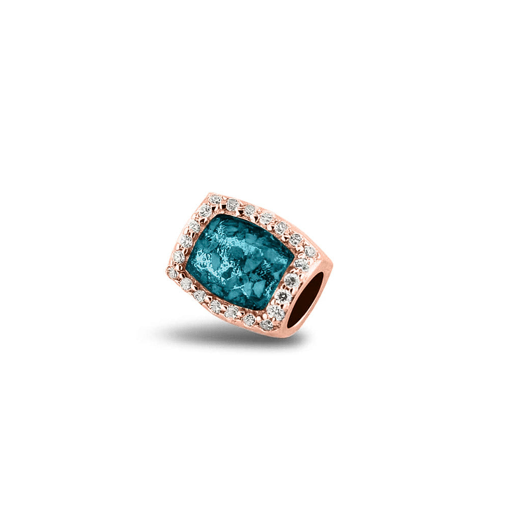 Asbedel rondom afgewerkt met zirkonia's die aan beide zijdes in twee compartimenten zichtbaar gevuld wordt met as of haar. Turquoise