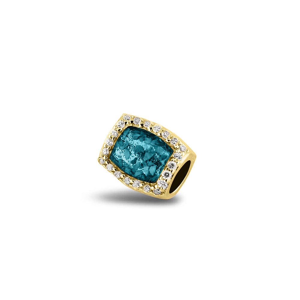 Asbedel rondom afgewerkt met zirkonia's die aan beide zijdes in twee compartimenten zichtbaar gevuld wordt met as of haar. Turquoise
