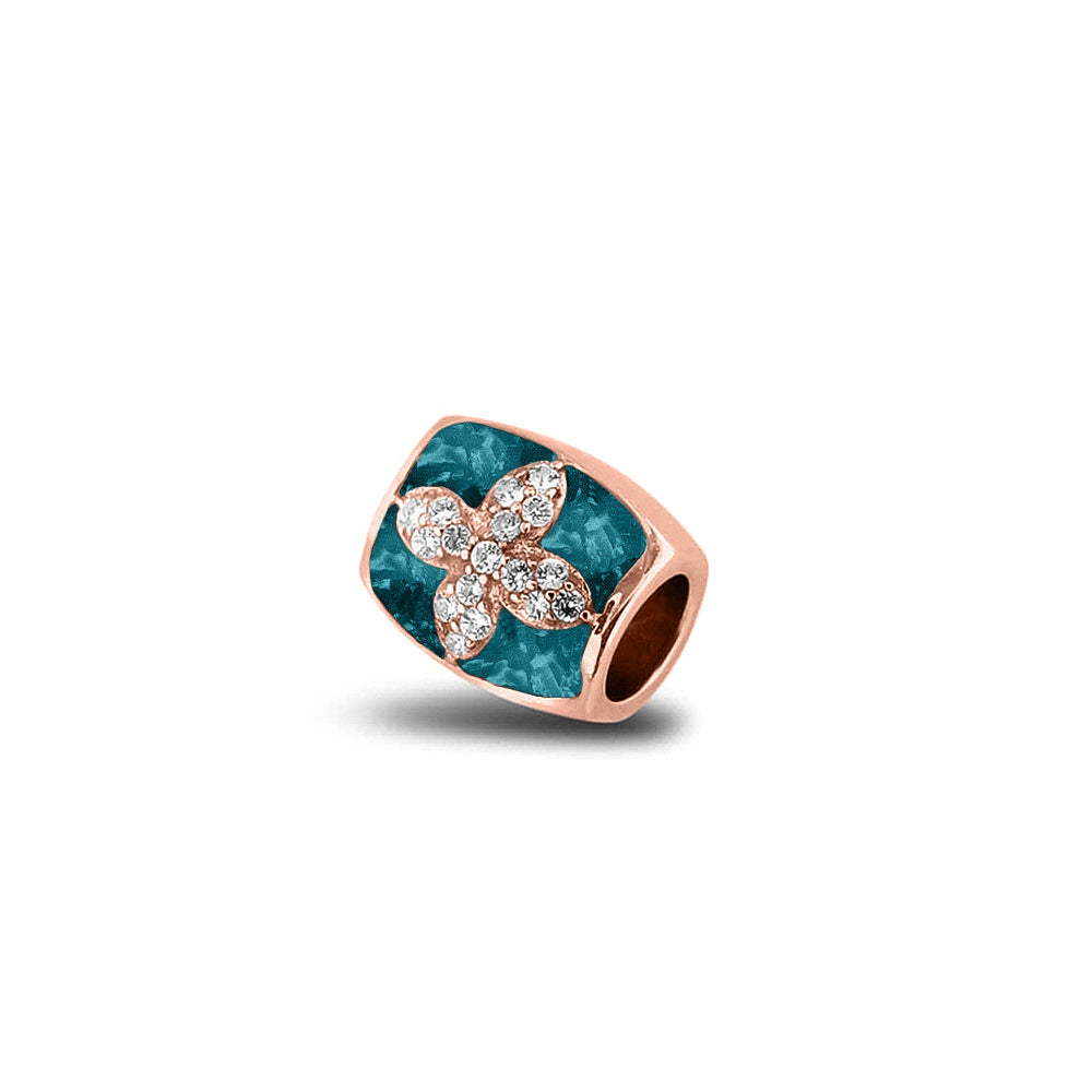 Asbedel met  zirkonia's, aan beide zijdes in twee compartimenten zichtbaar gevuld met as of haar. Turquoise