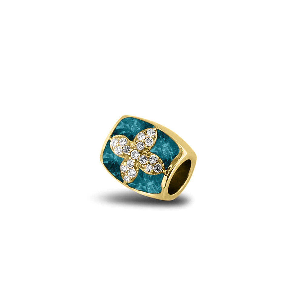 Asbedel met  zirkonia's, aan beide zijdes in twee compartimenten zichtbaar gevuld met as of haar. Turquoise