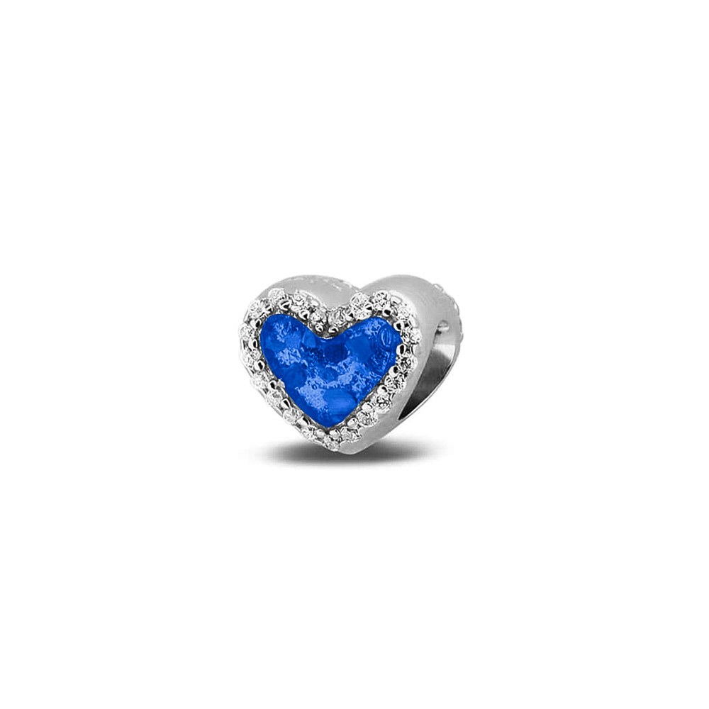 Hartvormige asbedel, met  zirkonia's rondom afgewerkt, die aan beide zijdes in twee compartimenten zichtbaar gevuld wordt met as of haar met een keuze in 20 kleuren. Blue