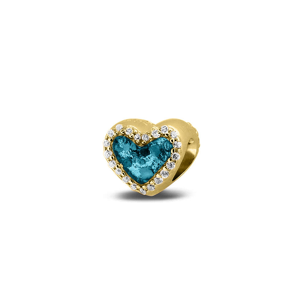 Hartvormige asbedel met  zirkonia's rondom afgewerkt, die aan beide zijdes in twee compartimenten zichtbaar gevuld wordt met as of haar met een keuze in 20 kleuren. Turquoise