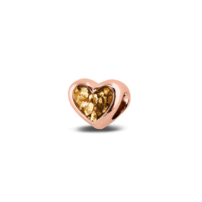 Hartvormige asbedel, aan beide zijdes zichtbaar gevuld met as of haar. Het vullen en sealen met onze speciale hars met een keuze in 20 kleuren, wordt in onze ambachtelijke edelsmederij gedaan. Gold