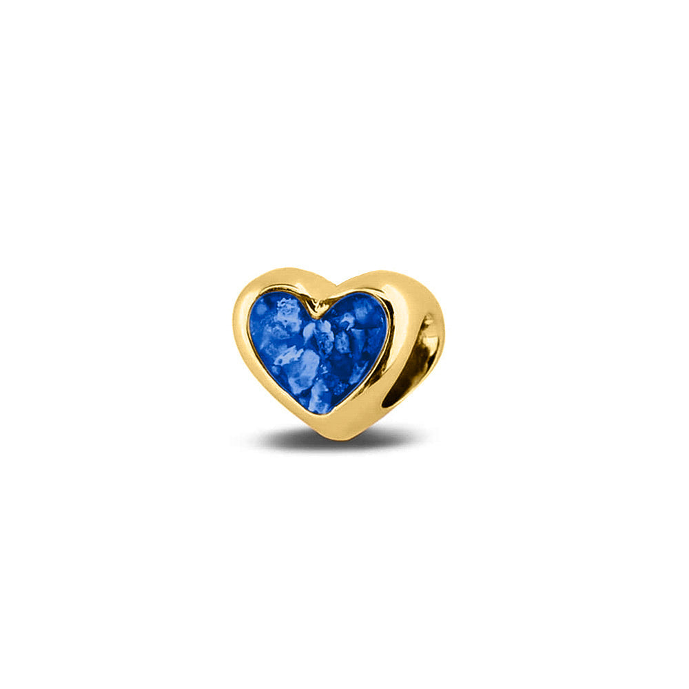 Hartvormige asbedel, aan beide zijdes zichtbaar gevuld met as of haar. Het vullen en sealen met onze speciale hars met een keuze in 20 kleuren, wordt in onze ambachtelijke edelsmederij gedaan. Blue