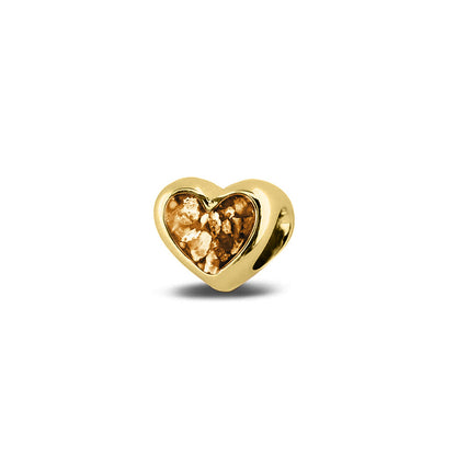 Hartvormige asbedel, aan beide zijdes zichtbaar gevuld met as of haar. Het vullen en sealen met onze speciale hars met een keuze in 20 kleuren, wordt in onze ambachtelijke edelsmederij gedaan. Gold
