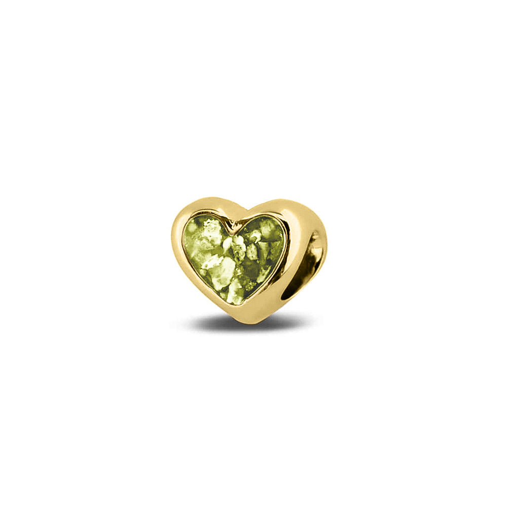 Hartvormige asbedel, aan beide zijdes zichtbaar gevuld met as of haar. Het vullen en sealen met onze speciale hars met een keuze in 20 kleuren, wordt in onze ambachtelijke edelsmederij gedaan. Olive