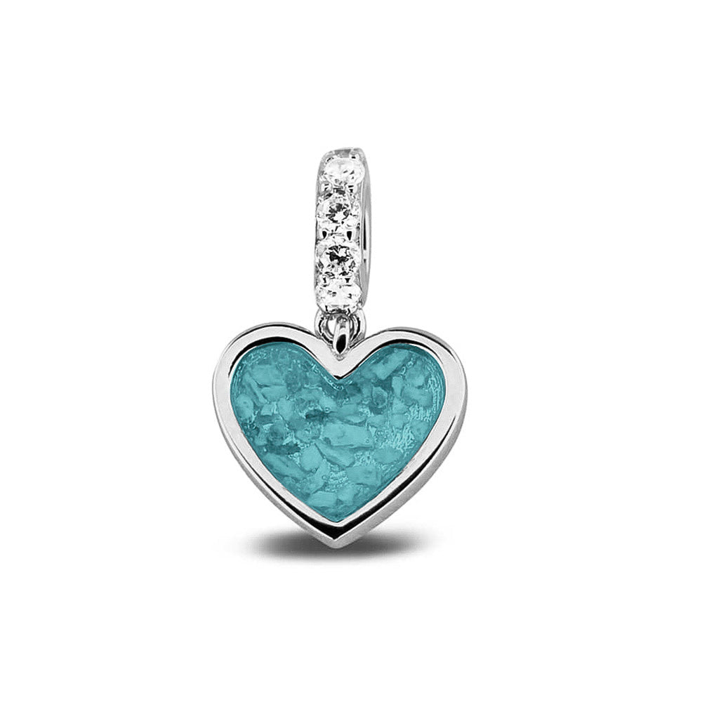 Hartvormige asbedel, het hangoog aan de buitenrand afgewerkt met zirkonia's die aan de voorzijde zichtbaar gevuld wordt met as of haar met een keuze in 20 kleuren. Aqua