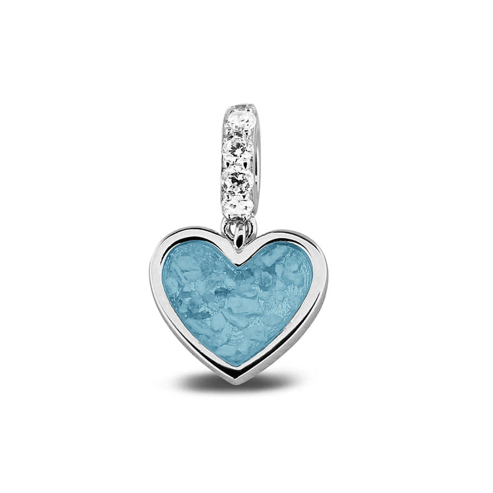 Hartvormige asbedel, het hangoog aan de buitenrand afgewerkt met zirkonia's die aan de voorzijde zichtbaar gevuld wordt met as of haar met een keuze in 20 kleuren. Baby