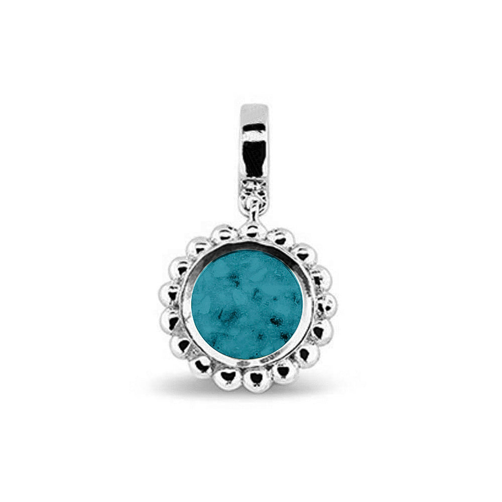 Asbedel die aan de voorzijde zichtbaar gevuld wordt met as of haar. Het vullen en sealen met een keuze in 20 kleuren, wordt in onze ambachtelijke edelsmederij gedaan. Turquoise