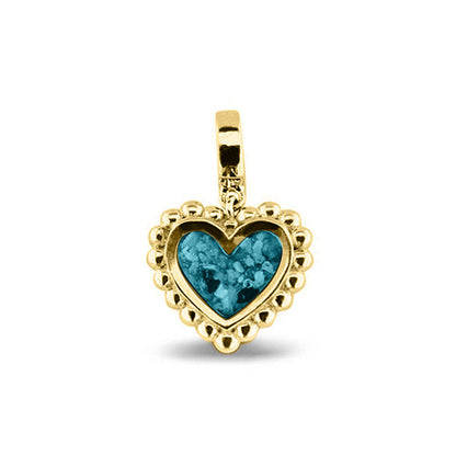 Hartvormige asbedel, die aan de voorzijde zichtbaar gevuld wordt met as of haar. Het vullen en sealen met een keuze in 20 kleuren, wordt in onze ambachtelijke edelsmederij gedaan. Turquoise
