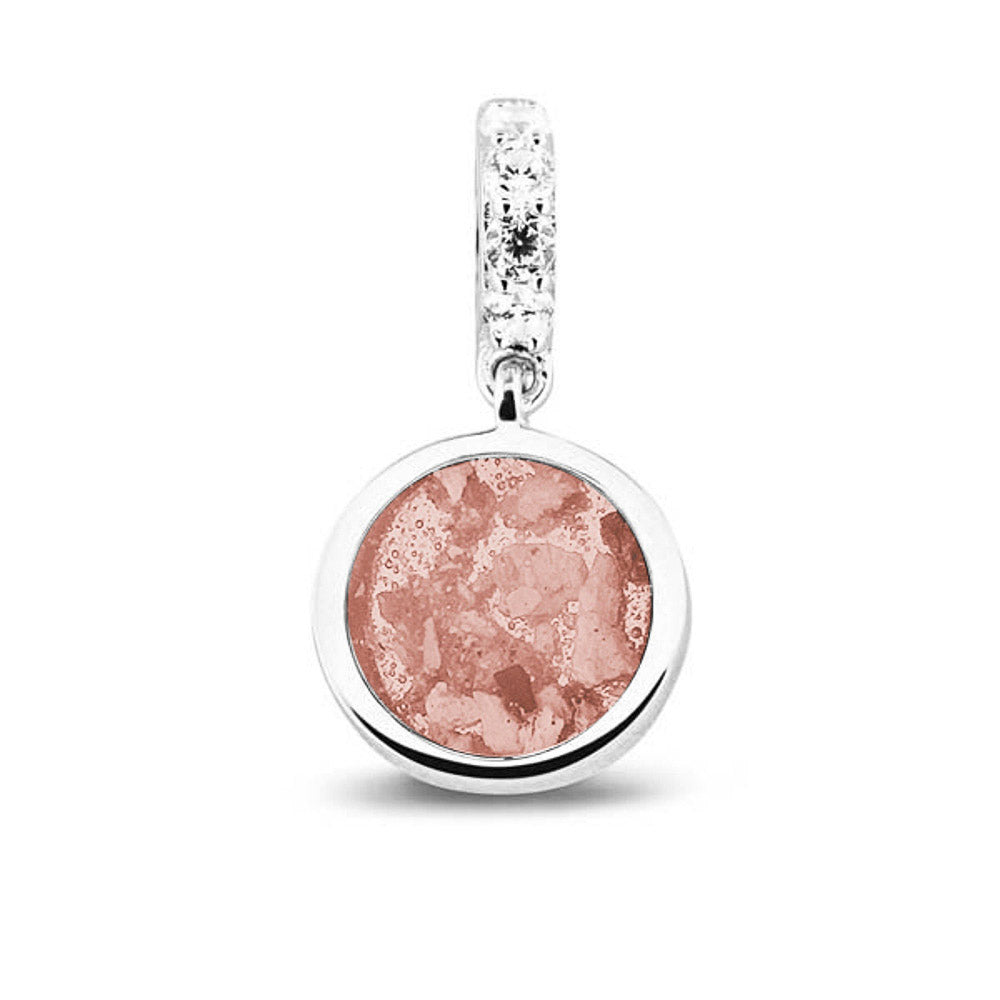 Asbedel rond subtiel design , het hangoog aan de buitenrand afgewerkt met zirkonia's, die aan de voorzijde zichtbaar gevuld wordt met as of haar met een keuze in 20 kleuren. Blush