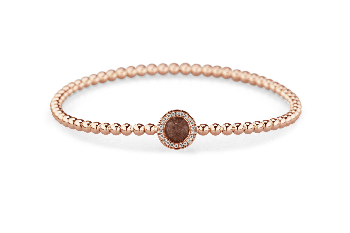 Flexibele as armband met rondje als compartiment gezet rondom met zirconia's voor as of haar. Brown