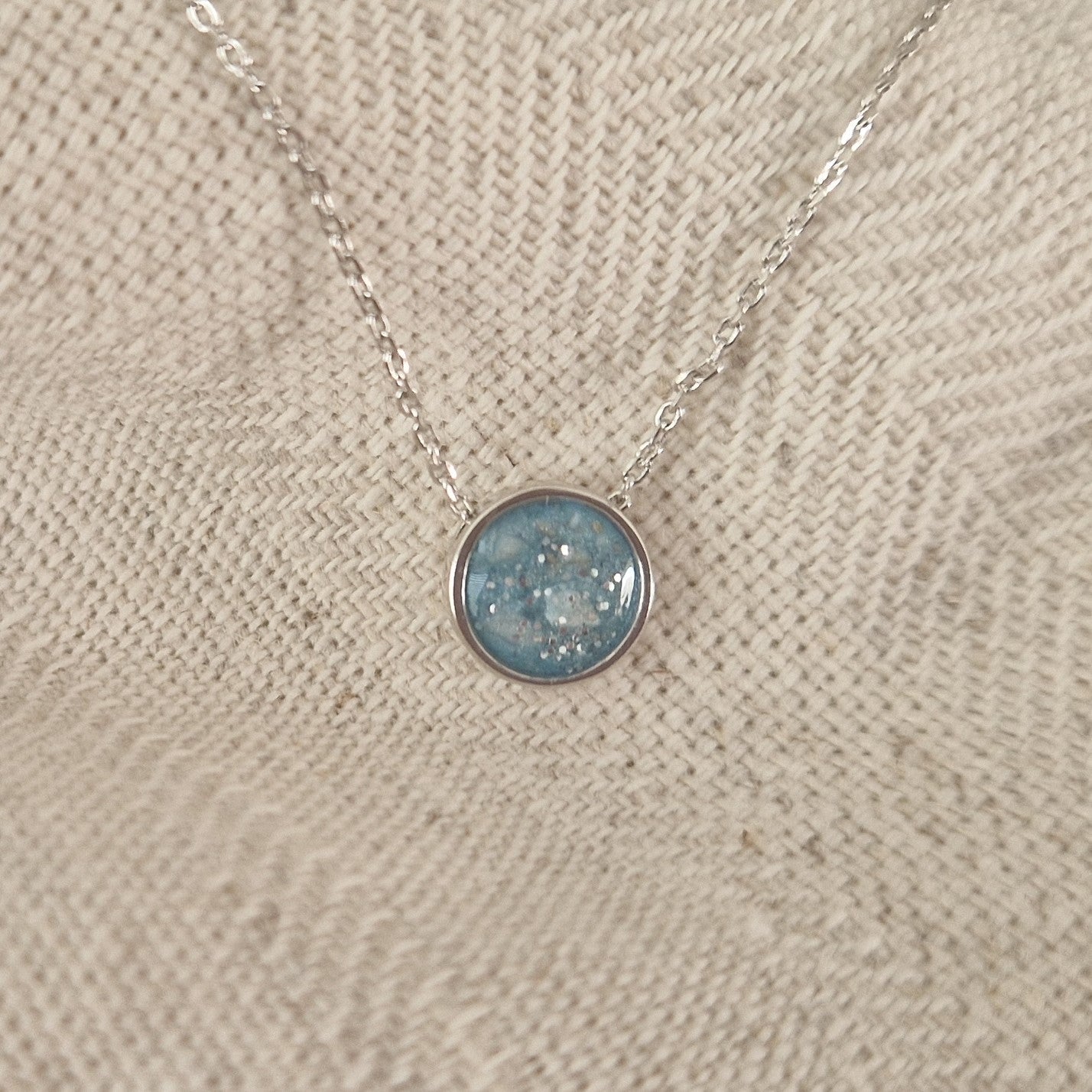 Ashanger rond, gedenksieraad, waar as en haar in verwerkt wordt. Alle