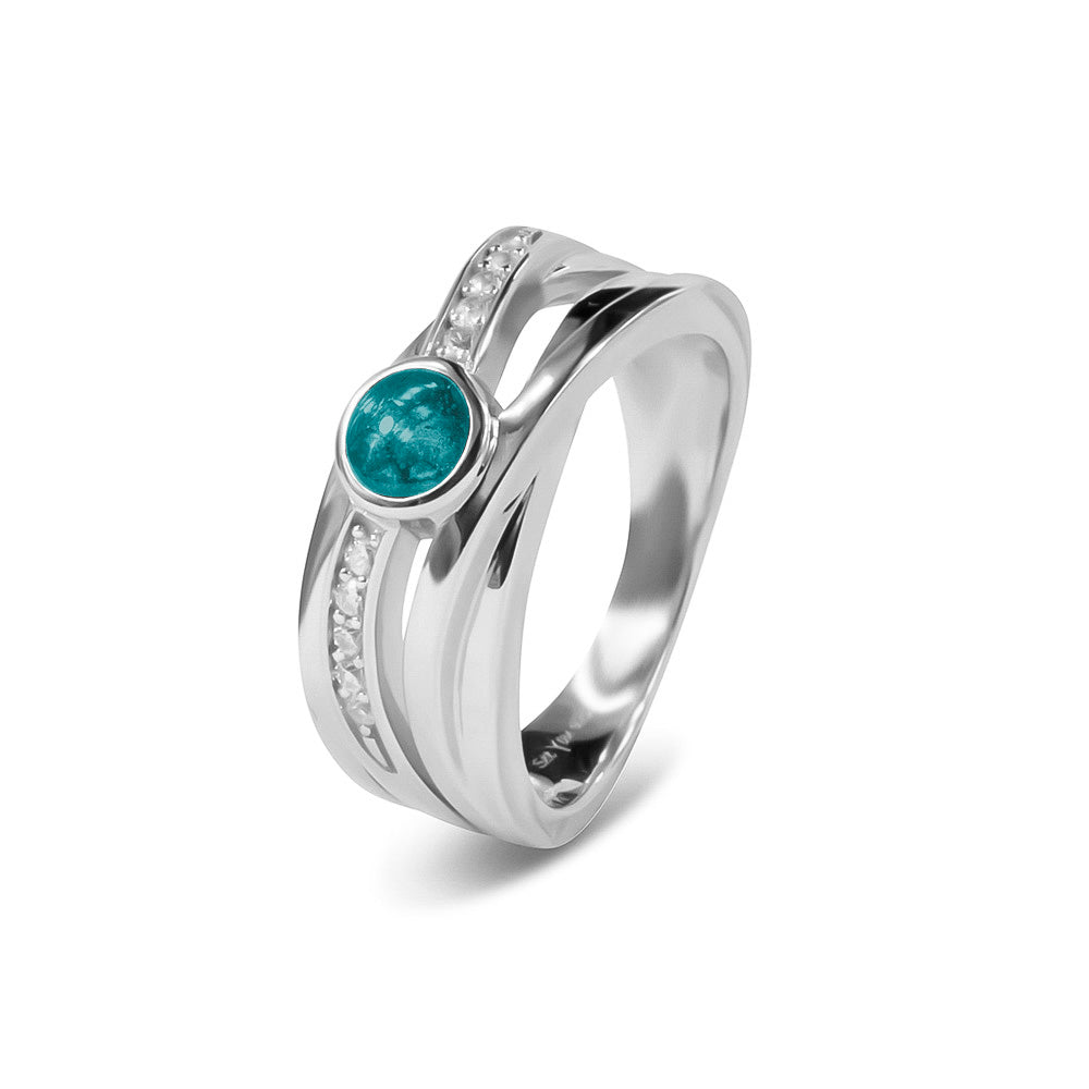 Gedenksieraad, creatieve ring 9 mm breed waar aan de bovenzijde zichtbaar as of haar verwerkt wordt in een deel van de ringband, een andere band is gezet met zirkonia's of diamanten naar keuze. Aqua