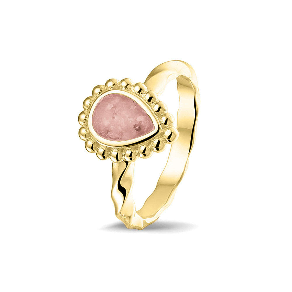 Gedenksieraad, asring met gedraaide scheen waar aan de bovenzijde in druppelvorm met parelrand zichtbaar as of haar (of eventueel melktandjes of moedermelk) verwerkt wordt.blush