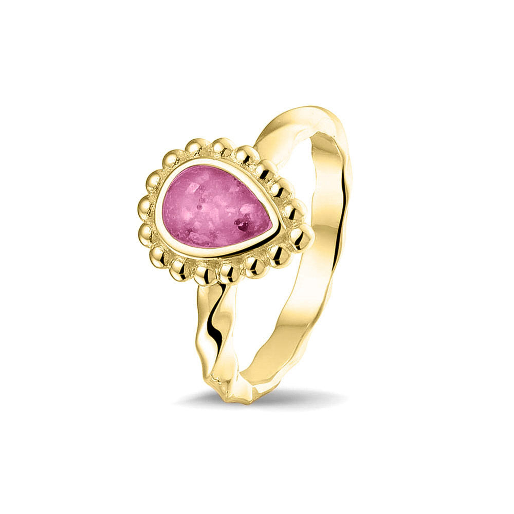 Gedenksieraad, asring met gedraaide scheen waar aan de bovenzijde in druppelvorm met parelrand zichtbaar as of haar (of eventueel melktandjes of moedermelk) verwerkt wordt.fluo