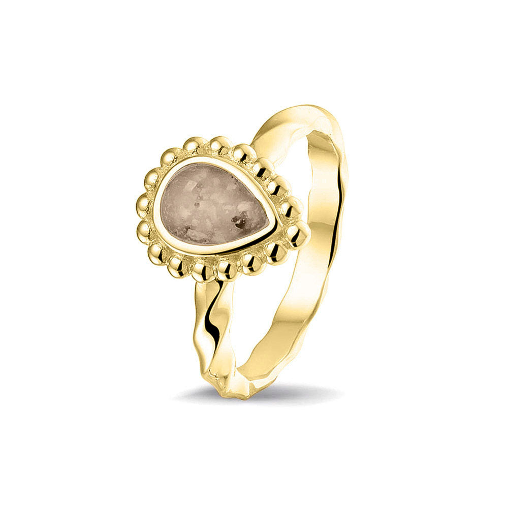 Gedenksieraad, asring met gedraaide scheen waar aan de bovenzijde in druppelvorm met parelrand zichtbaar as of haar (of eventueel melktandjes of moedermelk) verwerkt wordt.transparent