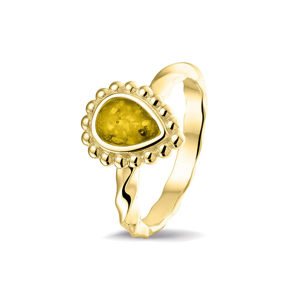 Gedenksieraad, asring met gedraaide scheen waar aan de bovenzijde in druppelvorm met parelrand zichtbaar as of haar (of eventueel melktandjes of moedermelk) verwerkt wordt.yellow