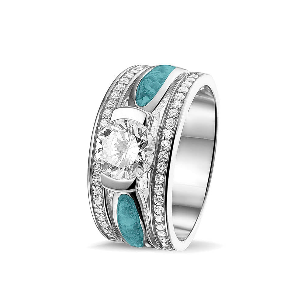 Asring 10 mm uit onze serie gedenksieraden, waar aan de bovenzijde zichtbaar as of haar verwerkt wordt in twee separate compartimenten met in het midden een zirkonia. Aqua