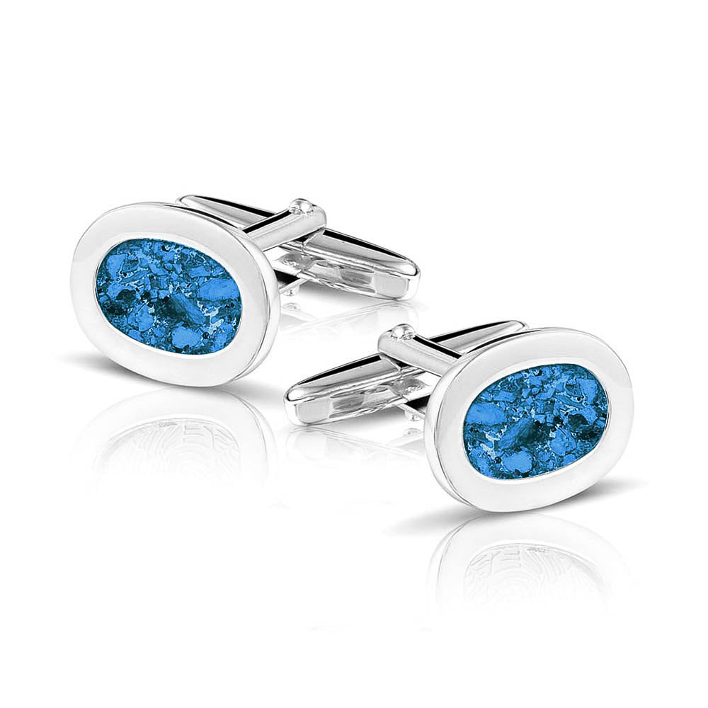 Manchetknopen met as, zichtbaar gevuld, als herinneringssieraad. Marine