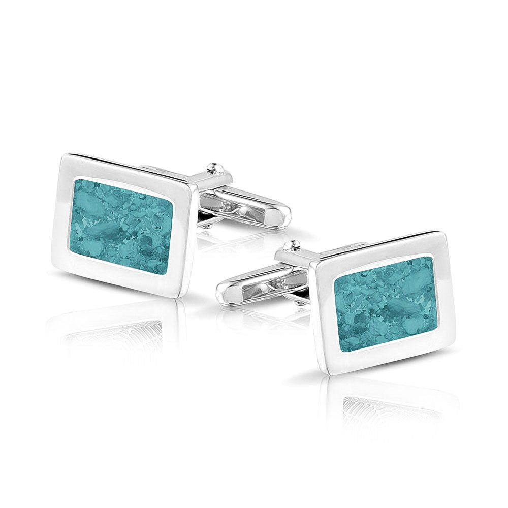 Manchetknopen met as, zichtbaar gevuld, als herinneringssieraad. aqua