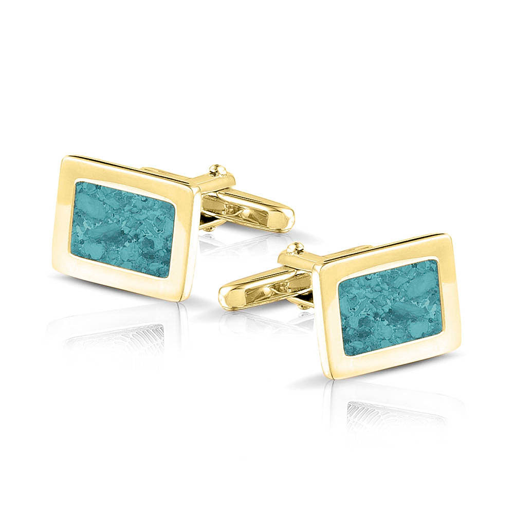 Manchetknopen met as, zichtbaar gevuld, als herinneringssieraad. aqua