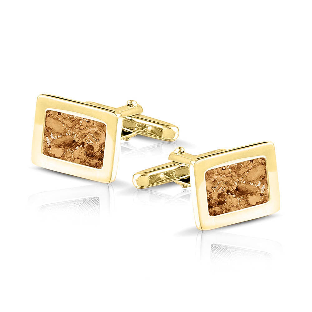 Manchetknopen met as, zichtbaar gevuld, als herinneringssieraad. gold