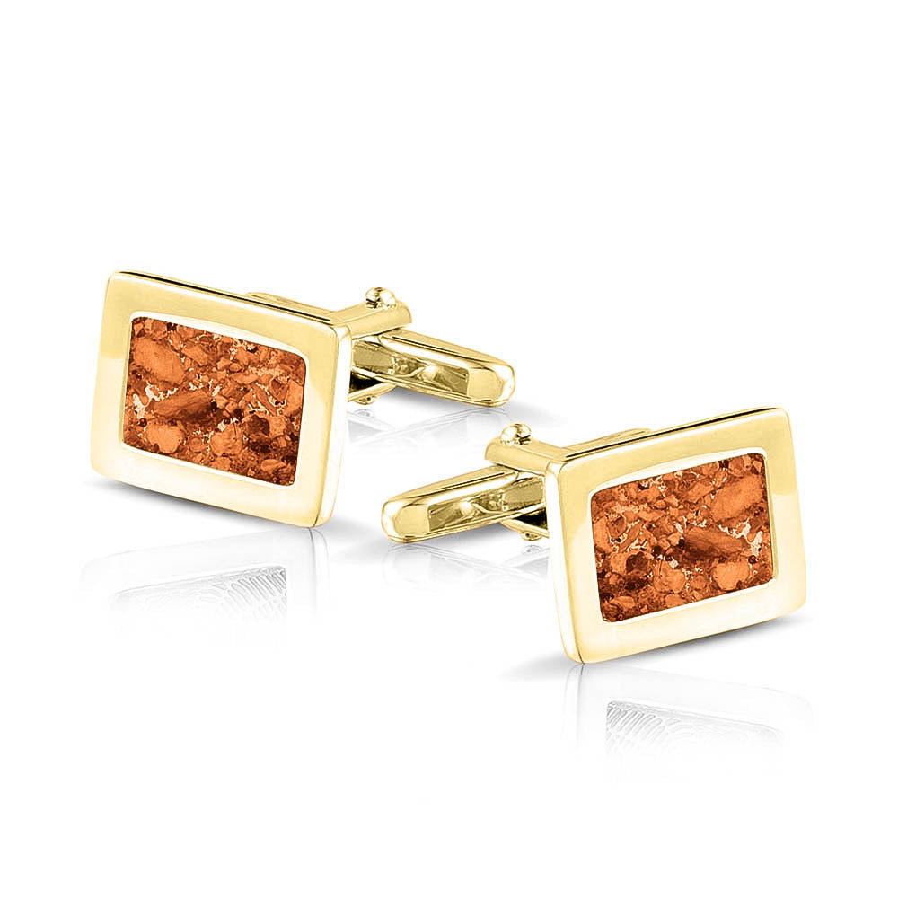 Manchetknopen met as, zichtbaar gevuld, als herinneringssieraad. orange