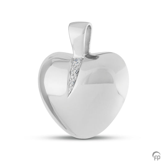 Ashanger hart met twee askamers. In zilver uitgevoerd met zirkonia's, in goud met diamanten.  De ashangers uit deze collectie gedenksieraden zijn zelf te vullen.