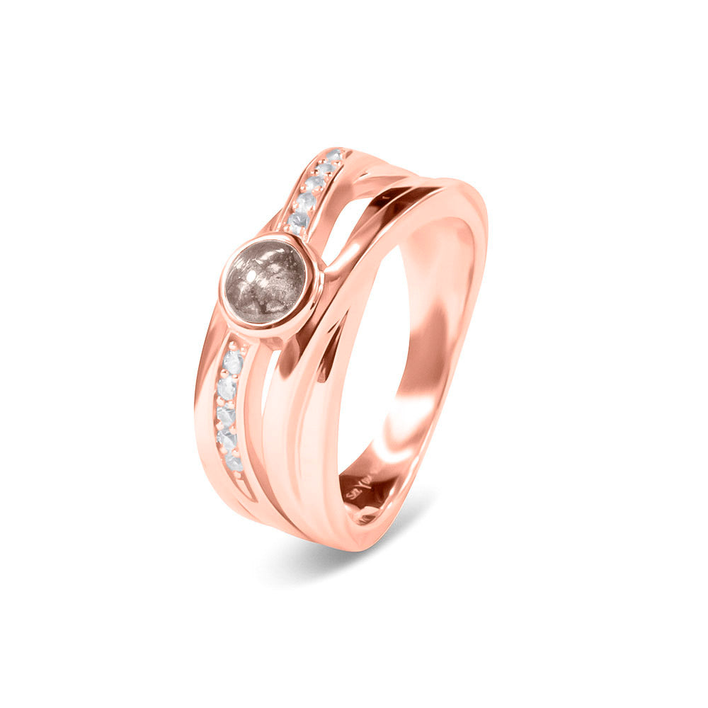 Gedenksieraad, creatieve ring 9 mm breed waar aan de bovenzijde zichtbaar as of haar verwerkt wordt in een deel van de ringband, een andere band is gezet met zirkonia's of diamanten naar keuze. Silver