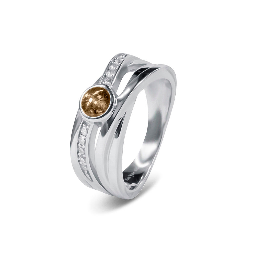 Gedenksieraad, creatieve ring 9 mm breed waar aan de bovenzijde zichtbaar as of haar verwerkt wordt in een deel van de ringband, een andere band is gezet met zirkonia's of diamanten naar keuze. Transparent